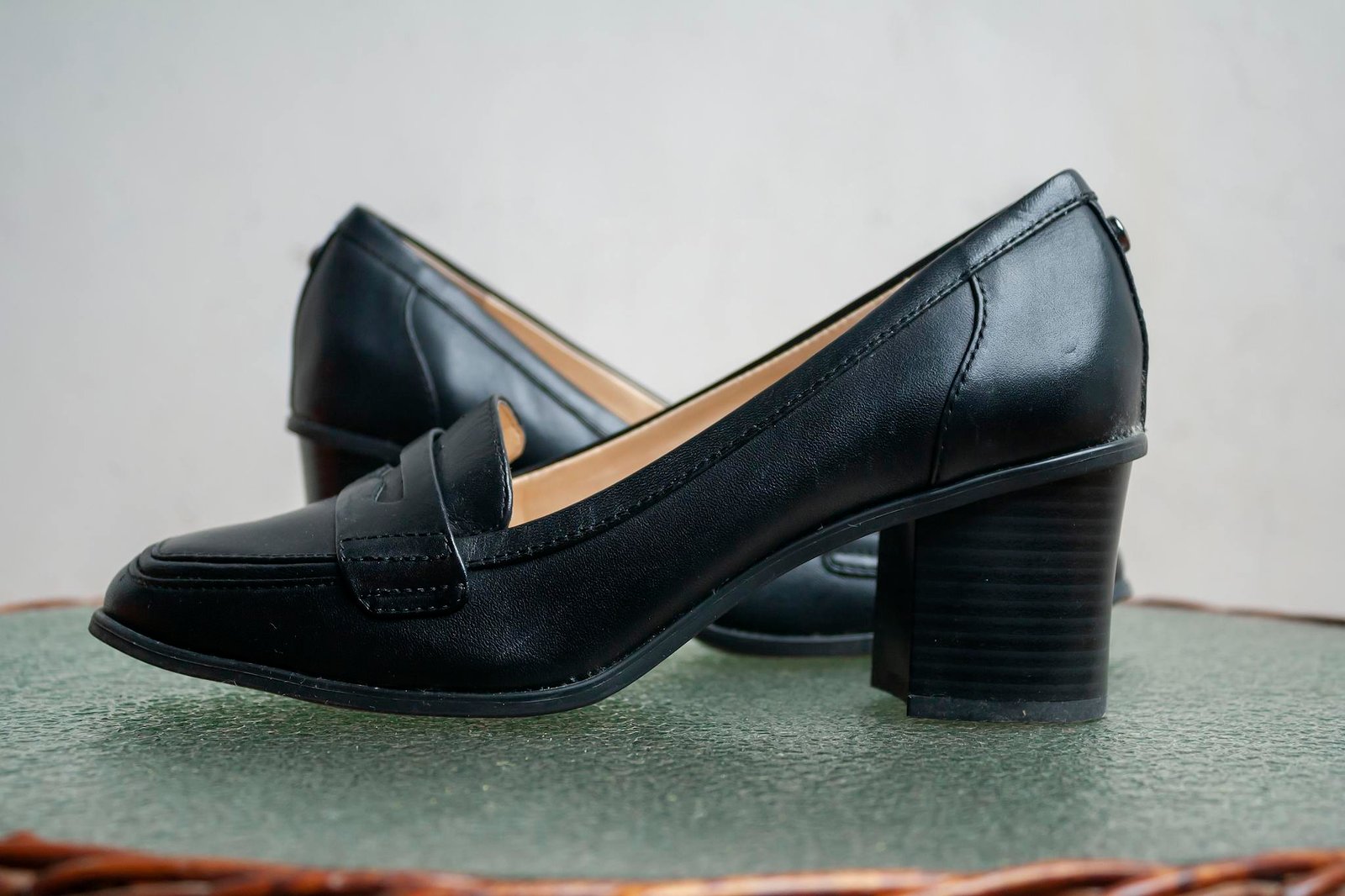 Stylish black leather loafers with comfortable block heels, perfect for formal and casual wear.